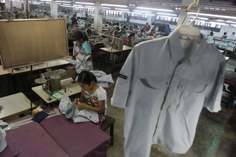 In this photo taken Saturday, April 21, 2012, a young worker sews a shirt at a garment factory in Yangon, Myanmar.