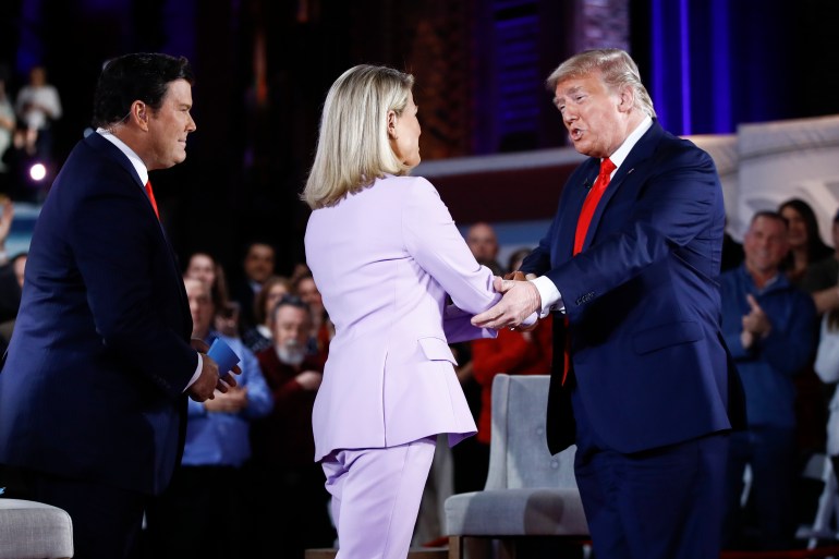 Former President Donald Trump greets FOX News Channel The Story anchor Martha MacCallum as co-moderator FNC's chief political anchor Bret Baier of Special Report looks on during a FOX News Channel Town Hall, in Scranton, Pa., Thursday, March 5, 2020.