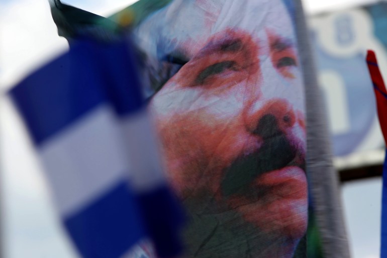 A banner emblazoned with an image of Nicaragua's President Daniel Ortega is waved by a supporter in Managua, Nicaragua, April 30, 2018. Ortega has forced hundreds of opposition figures into exile, stripping them of their citizenship, seizing their properties and declaring them “traitors of the homeland.” 