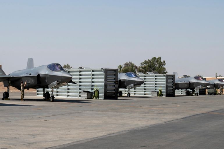 A row of parked fighter jets