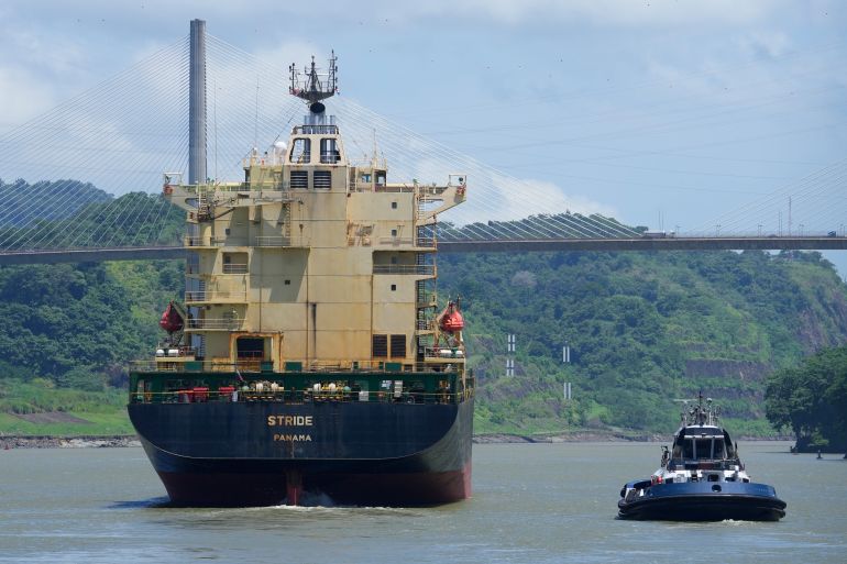 A cargo ship sails near the Pedro Miguel Locks on Panama Canal in Panama City, Thursday, Aug. 3, 2023. The Panama Canal Authority said it is limiting traffic to 32 daily ship transits through the canal after months of drought and expect less income in 2024 due to the ongoing water crisis. (AP Photo/Arnulfo Franco)