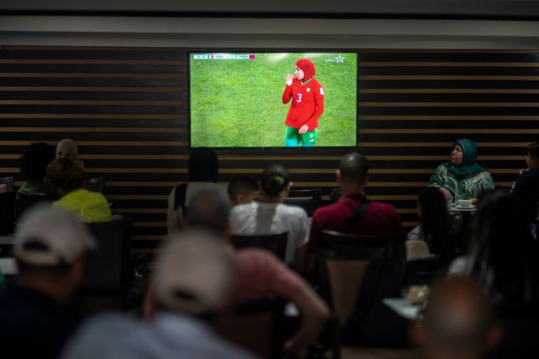 Moroccans watch a football game in a coffee shop in Rabat