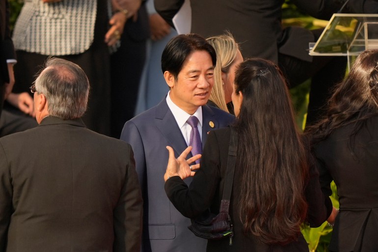 William Lai speaks to another guest, seen from behind, at the swearing-in ceremony.