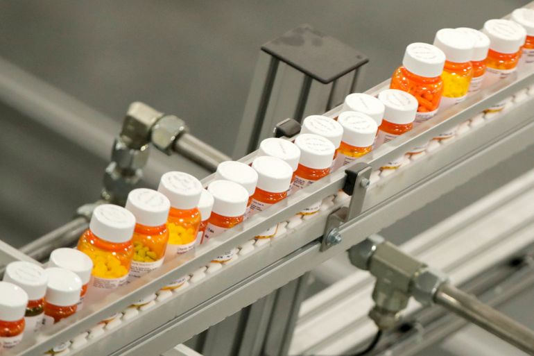 FILE- Bottles of medicine ride on a belt at a mail-in pharmacy warehouse in Florence, N.J., July 10, 2018. President Joe Biden's administration will announce on Tuesday, Aug. 29, 2023, the first prescription drugs being targeted by the U.S. government for price negotiations as part of an effort to lower Medicare costs. (AP Photo/Julio Cortez, File)