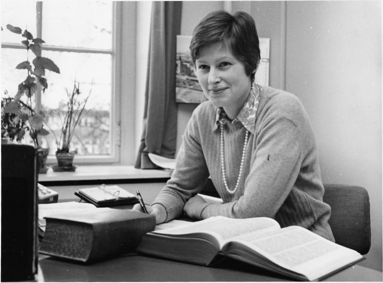 A photo of Angela Kane sitting at a desk.