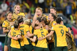 Players of Australia celebrate their side's victory in the penalty shoot out