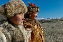 Semser Bahitnur, 23, right, and her sister Aigbek, 14, near their family cabin in Altai, Mongolia [Asha Tanna/Al Jazeera]