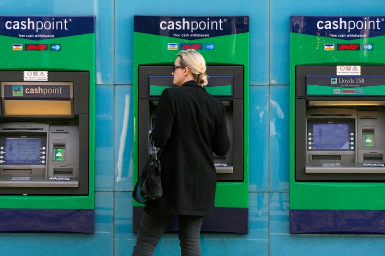 A woman uses a Lloyds ATM machine in Chelsea, west London February 27, 2009