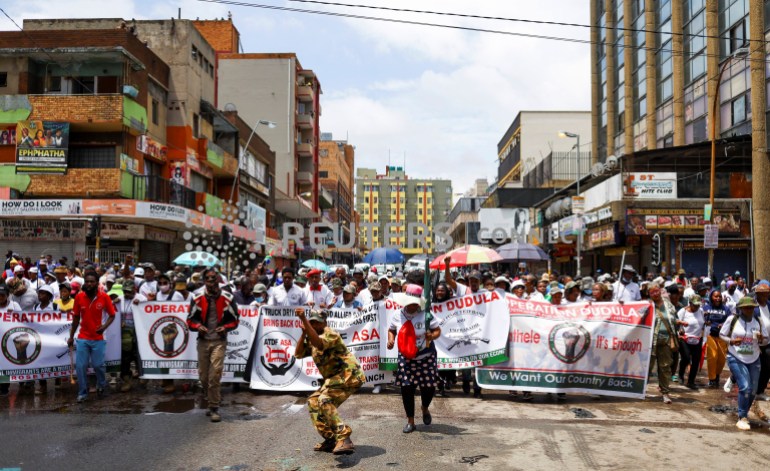 Members of the South African anti-migrant group, operating under the slogan "Put South Africa First", take part in a peaceful campaign to force undocumented foreigners out of informal trading at Johannesburg's Hillbrow