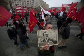 A demonstrator shows a picture of former Chilean president Salvador Allende during a rally to mark the anniversary of the 1973 coup