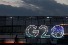 A man walks past an installation on a skywalk ahead of the G20 Summit in New Delhi, India, September 6, 2023