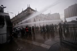 Protesters clash with riot police during a rally-march ahead of the 50th anniversary of the 1973 Chilean military coup