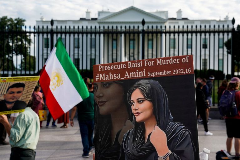 Iranian American protesters hold photo of Mahsa Amini outside the White House