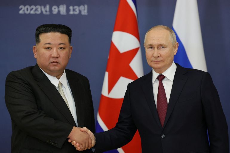 Russia's President Vladimir Putin shakes hands with North Korea's leader Kim Jong Un