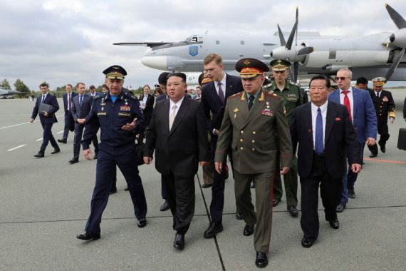 North Korea's leader Kim Jong Un, centre, and Russia's Defence Minister Sergei Shoigu, right, inspect Russian military aircraft and missiles put on display at Knevichi aerodrome near Vladivostok in the Primorsky region, Russia, on September 16, 2023 [Russian Defence Ministry/handout via Reuters]