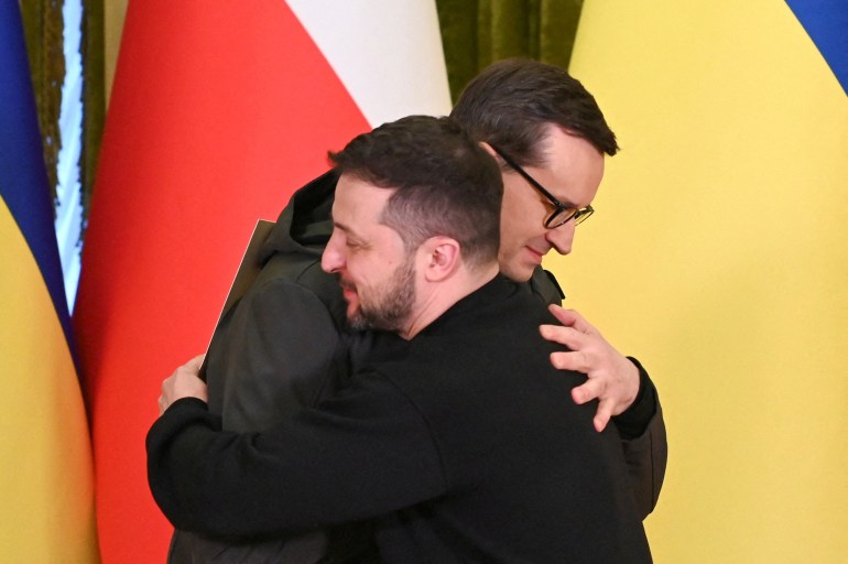 FILE PHOTO: Ukraine's President Volodymyr Zelenskiy and Polish Prime Minister Mateusz Morawiecki embrace during a joint news briefing on a day of the first anniversary of Russia's attack on Ukraine, in Kyiv, Ukraine February 24, 2023. REUTERS/Viacheslav Ratynskyi/File Photo
