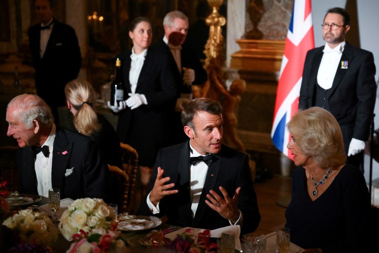 French President Emmanuel Macron, Britain's King Charles and Britain's Queen Camilla attend a state banquet at the Palace of Versailles