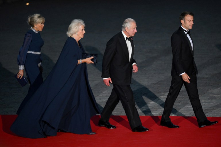 French president's wife Brigitte Macron, Britain's Queen Camilla, Britain's King Charles and French President Emmanuel Macron arrive for a state banquet at the Palace of Versailles