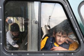 A refugee boy from the Nagorno-Karabakh region looks out of a car window upon arrival at a temporary accommodation centre in the town of Goris, Armenia, on September 25, 2023 [Irakli Gedenidze/Reuters]
