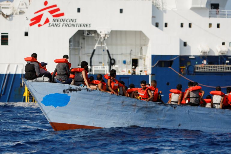 A group of 61 migrants on a wooden boat are rescued by crew members of the Geo Barents migrant rescue ship, operated by Medecins Sans Frontieres (Doctors Without Borders), in international waters off the coast of Libya in the central Mediterranean Sea