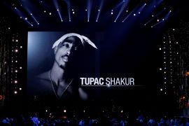 Screen shows photo of Tupac Shakur