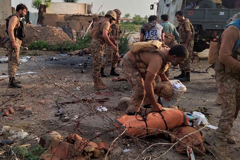 Pakistani army personnel inspect the site of a bombing in Khyber Pakhtunkhwa province in August 2023