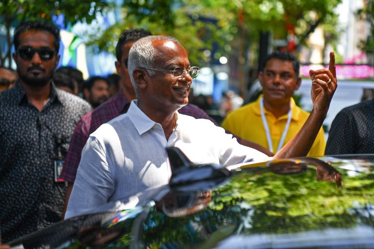 Ibrahim Mohamed Solih (C), the incumbent Maldives President shows his ink marked finger after casting his ballot during presidential election in Male on September 9, 2023. 