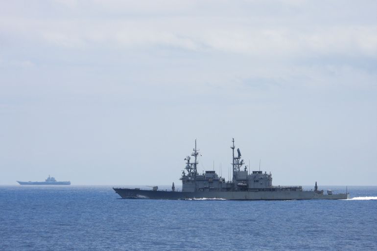 This undated handout photo released by the Taiwan Defense Ministry on September 13, 2023 shows Chinese aircraft carrier Shandong being monitored by a Taiwanese Keelung class warship at sea.