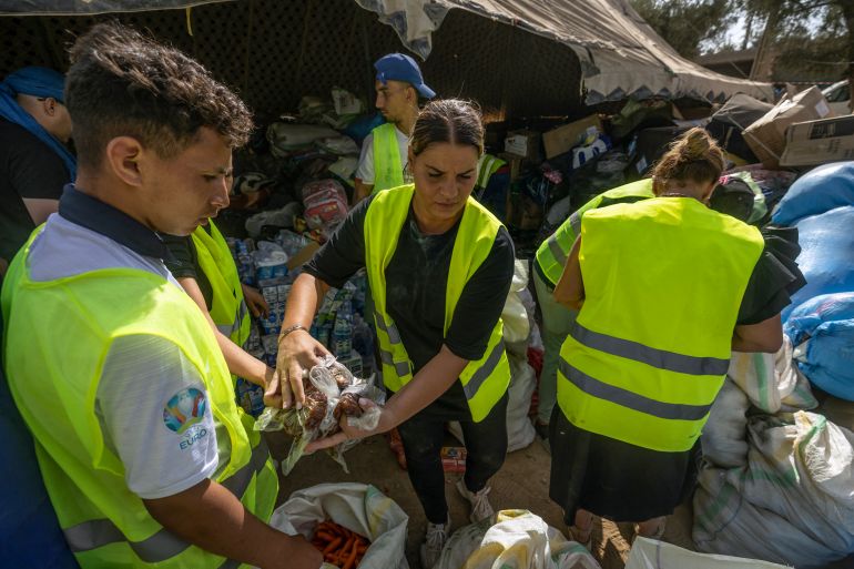 Volunteers sort out aid parcels in the mountain village of Tafeghaghte, southwest of Marrakesh city on September 15, 2023, following a devastating earthquake