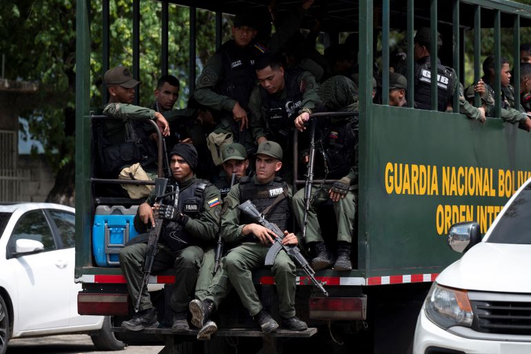 Members of the Bolivarian National Guard (GNB) arrive after authorities seized control of the Tocoron prison in Tocoron, Aragua State, Venezuela
