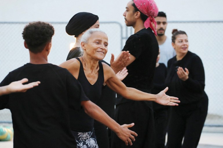 Tunisian actress and dancer Sondos Belhassen performs in the midst of a group