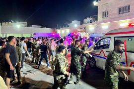 Soldiers and emergency responders gather around ambulances outside the Hamdaniyah general hospital in Al-Hamdaniyah, Iraq, on September 27, 2023, following a fire at a wedding event hall where at least 100 people were killed and more than 150 injured [Zaid Al-Obeidi/AFP]