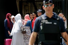 epa05991625 French police perform identity checks during an event organized by French-Algerian businessman Rachid Nekkaz in Cannes, France, 26 May 2017. Nekkaz scheduled a Burkini beach party in Cannes, but French authorities banned the event and performed ID checks on muslim women trying to get to the beach. EPA/SEBASTIEN NOGIER