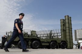 A Russian military official walks in front of an S-400 &#39;Triumf&#39; missile defence system outside Moscow, Russia, in 2017. Recent destruction of two S-400 systems in Crimea by Ukrainian forces may mean that just three of the sophisticated missile systems are now protecting the Russian-annexed peninsula [File: Yuri Kochetkov/EPA]