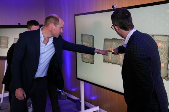 Britain's Prince William, left, looks for ivory hidden in a suitcase on a scan during his visit to Microsoft HQ to learn how new AI scanning technology can increase detection of illegal wildlife products being trafficked through international airports, in Reading, England, Thursday Nov. 18, 2021. (Steve Parsons/Pool Photo via AP)