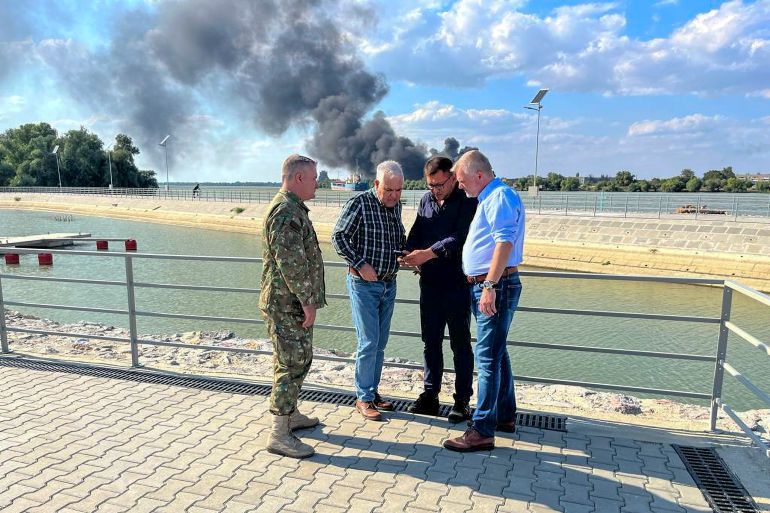 In this image released by the Romanian Defense Ministry, Defense Minister Angel Tilvar, second from left, visits areas in the Danube Delta close to the Ukrainian border, Wednesday, Sept. 6, 2023. Romania's defense minister said Wednesday that pieces apparently of a drone from Russia's recent attacks on Ukraine's port on the Danube River have been found on the territory of his country. Romania is a NATO member. (Romanian Defense Ministry via AP)