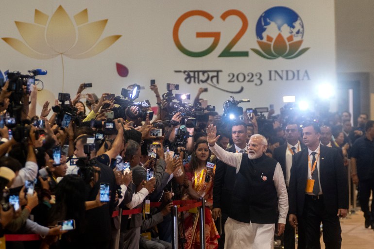 Indian Prime Minister Narendra Modi waves during his visit to the International Media Center at the end of the G20 Summit