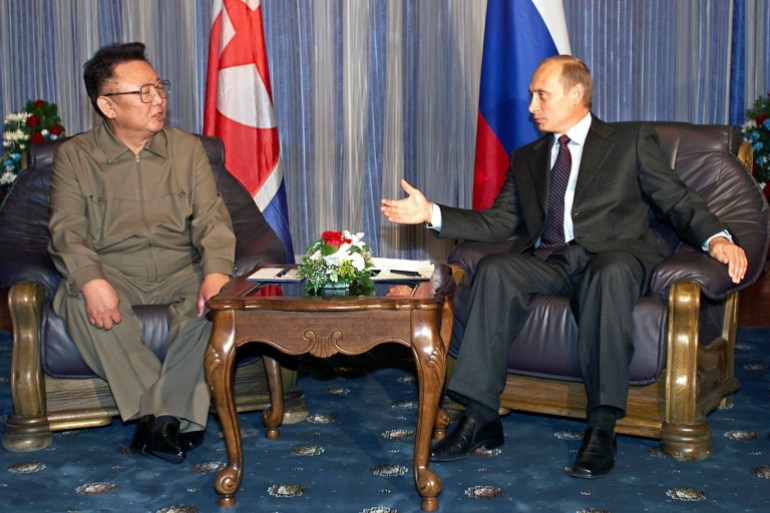 Russian President Vladimir Putin gestures as he talks to North Korean then-leader Kim Jong Il during their meeting in Vladivostok, Russia, on August 23, 2002.
