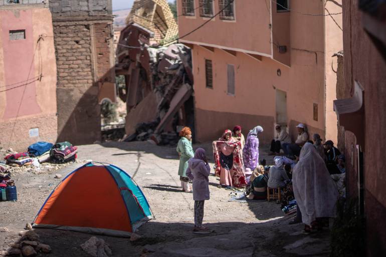 People affected by an earthquake camp outside their homes, 