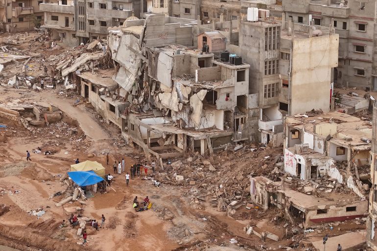 Rescuers and relatives of victims set up tents in front of collapsed buildings in Derna, Libya