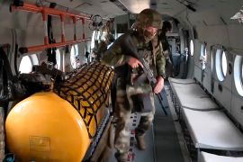 In this photo taken from video released by Russian Defense Ministry Press Service on Sunday, Sept. 24, 2023, soldiers take their places inside a military helicopter of the Russian air force [File: Russian Defense Ministry Press Service via AP Photo]