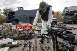Kosovo police officers display seized weapons and military equipment during the police operation in the village of Banjska in a police camp in Mitrovica, Kosovo on September 25, 2023 [Visar Kryeziu/AP]