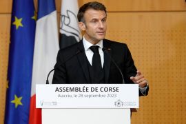 French President Emmanuel Macron addresses the Corsican Assembly in Ajaccio [Pascal Pochard-Casabianca, Pool via AP]