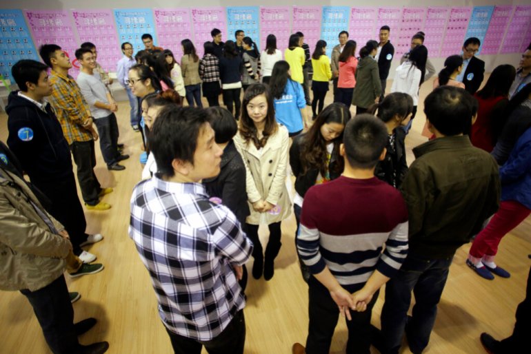 Participants take part in a bachelor's meeting event during a mass match-making event ahead of Singles Day in Shanghai, China, Saturday, Nov. 9, 2013. Singles Day was begun by Chinese college students in the 1990s as a version of Valentine's Day for people without romantic partners. The timing was based on the date Nov. 11, or "11.11"  four singles. (AP Photo/Eugene Hoshiko)