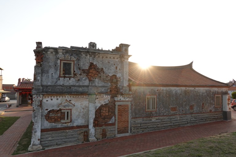 A photo of a brick house in northeastern Kinmen riddled with bullet holes.