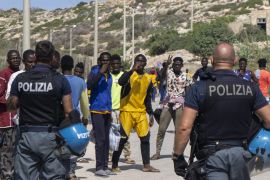 Italian police coralling refugees and migrants on the island of Lampedusa, Italy [‪File: Lidia Ginestra Giuffrida‬/Al Jazeera]