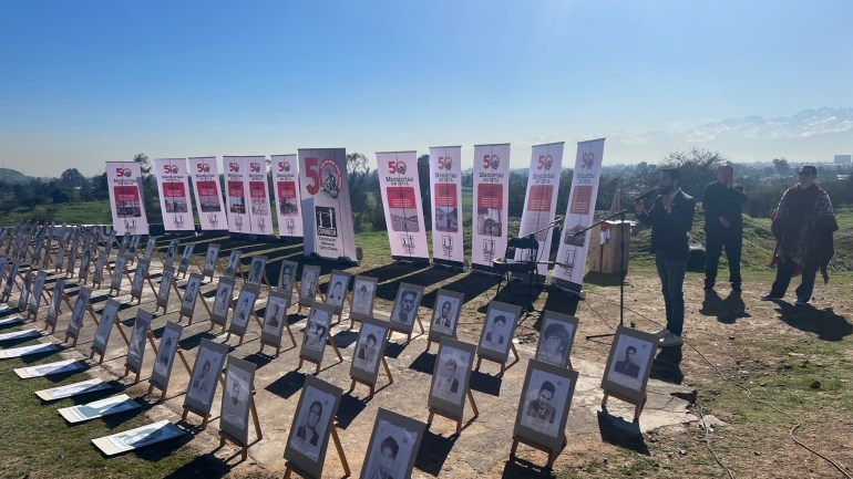 Photos of people disappeared during Chile's military dictatorship are laid out in rows during a memorial in Santiago