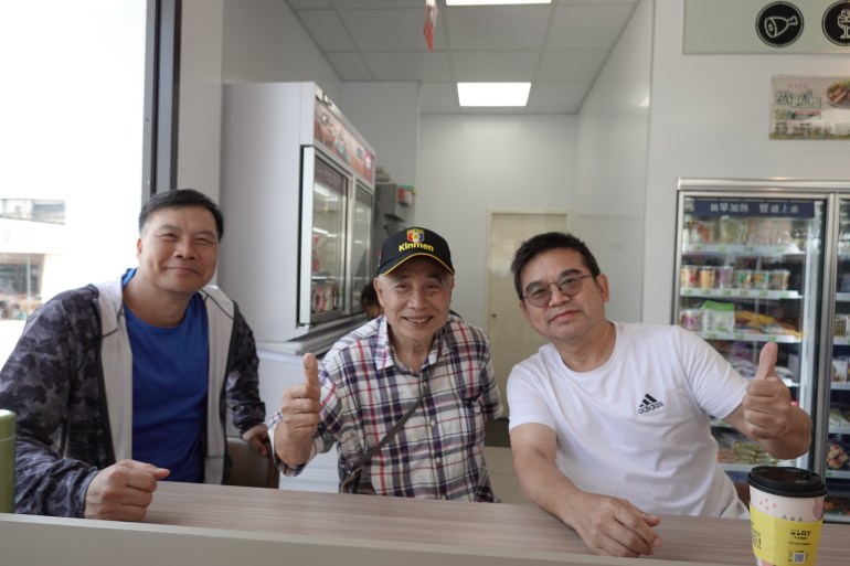 A photo of Pecan Shui (right) with two of his friends in a convenience store.