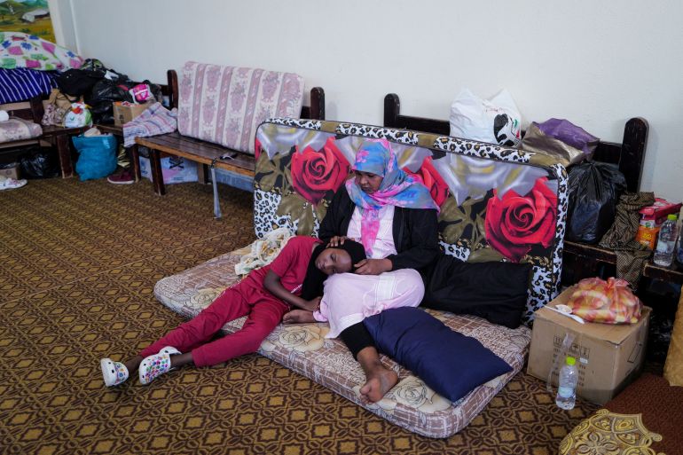 Ichtiyak, 33, who survived the deadly storm that hit Libya, sits with her daughter at the Um almoumanen school, where they take shelter in Derna, Libya
