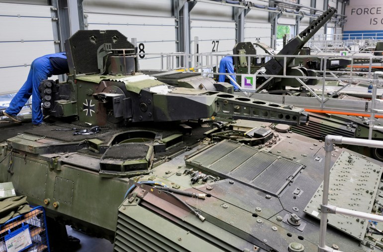 Employees working on Puma fighting vehicles on a Rheinmetall production line